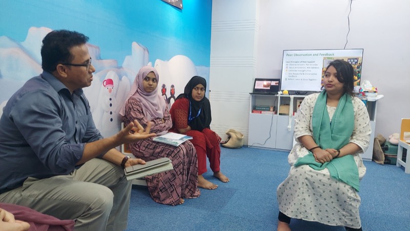 Facilitator in a coaching conversation with teachers